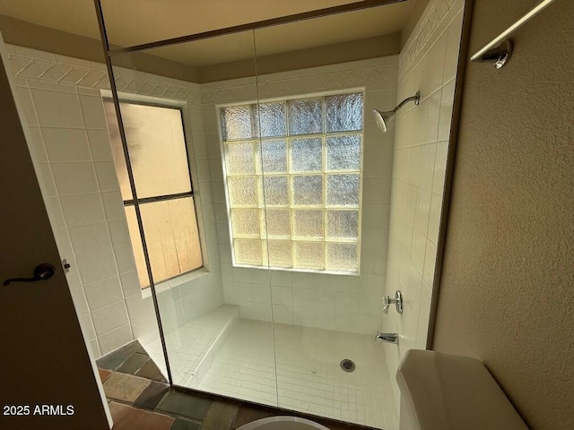 bathroom with tiled shower