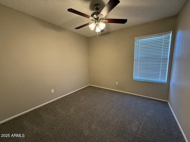 spare room with ceiling fan, carpet flooring, and a textured ceiling