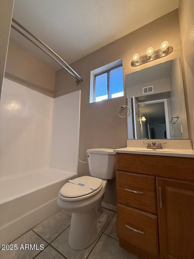 full bathroom featuring vanity, tile patterned floors, toilet, and bathtub / shower combination