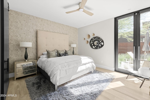 bedroom featuring ceiling fan, hardwood / wood-style floors, and access to exterior