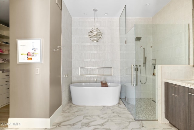 bathroom featuring tile walls, vanity, and independent shower and bath