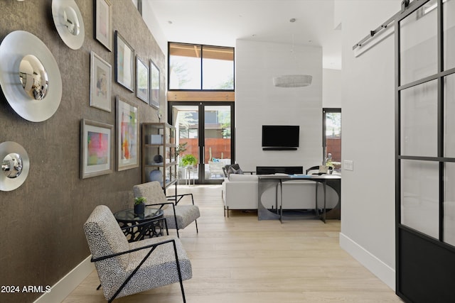 interior space featuring light hardwood / wood-style flooring and a high ceiling