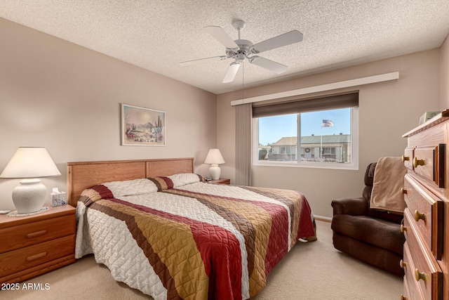 carpeted bedroom with a textured ceiling and ceiling fan