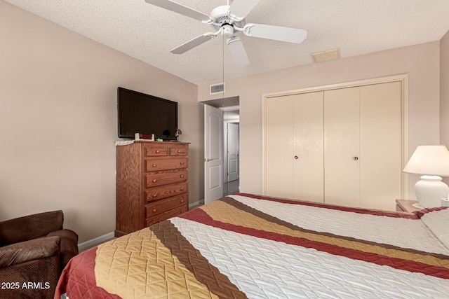 bedroom with a textured ceiling, a closet, and ceiling fan