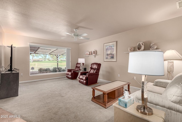 carpeted living room with ceiling fan and a textured ceiling