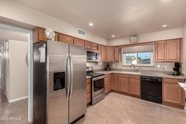 kitchen featuring sink, light tile patterned floors, and stainless steel appliances