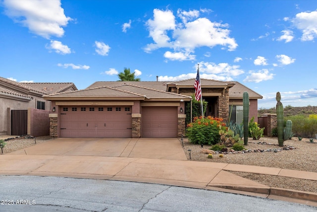 2761 W Via Calabria, Phoenix, AZ 85086 - prairie-style house with stone siding, a tile roof, stucco siding, an attached garage, and driveway