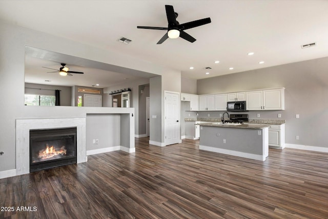 2761 W Via Calabria, Phoenix, AZ 85086 - unfurnished living room with ceiling fan, a sink, baseboards, dark wood-style floors, and recessed lighting
