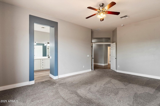 2761 W Via Calabria, Phoenix, AZ 85086 - unfurnished bedroom with light carpet, baseboards, and connected bathroom