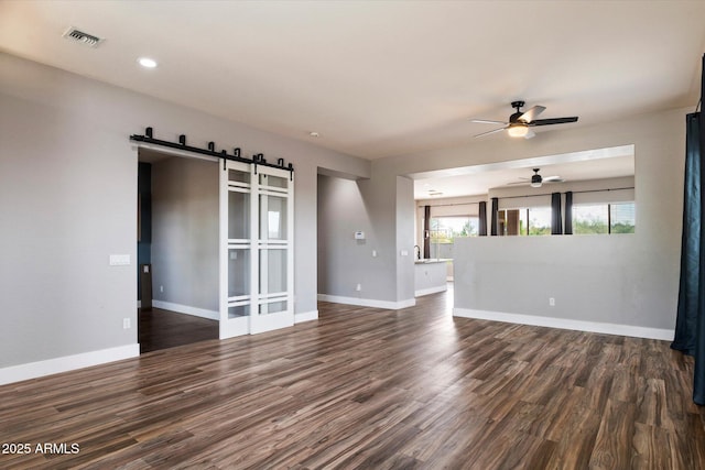 2761 W Via Calabria, Phoenix, AZ 85086 - unfurnished living room featuring a barn door, ceiling fan, dark wood-style floors, baseboards, and recessed lighting