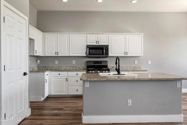 2761 W Via Calabria, Phoenix, AZ 85086 - kitchen featuring stainless steel appliances, dark wood-style floors, light stone counters, white cabinets, and recessed lighting