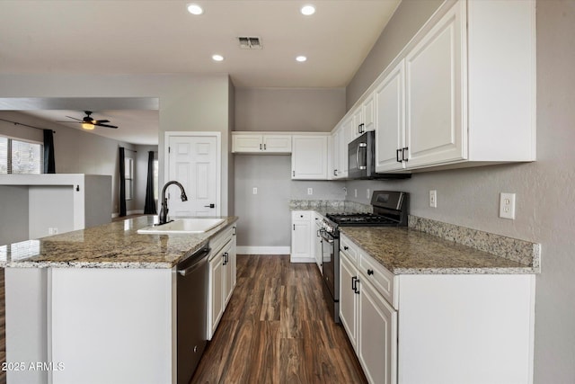 2761 W Via Calabria, Phoenix, AZ 85086 - kitchen with stainless steel appliances, a sink, dark wood finished floors, ceiling fan, and white cabinets