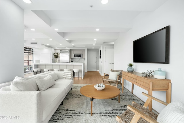 living room with recessed lighting and light wood-style flooring