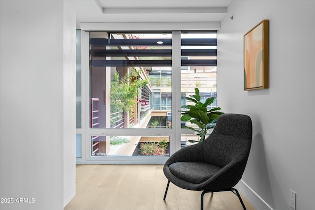 sitting room featuring baseboards and wood finished floors