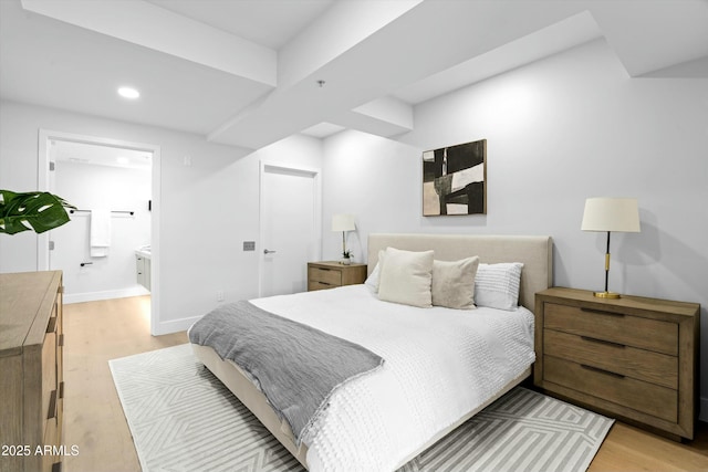 bedroom with ensuite bath, light wood-style flooring, baseboards, and recessed lighting