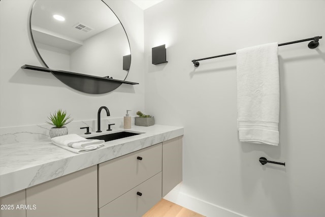 bathroom with wood finished floors, vanity, visible vents, and recessed lighting