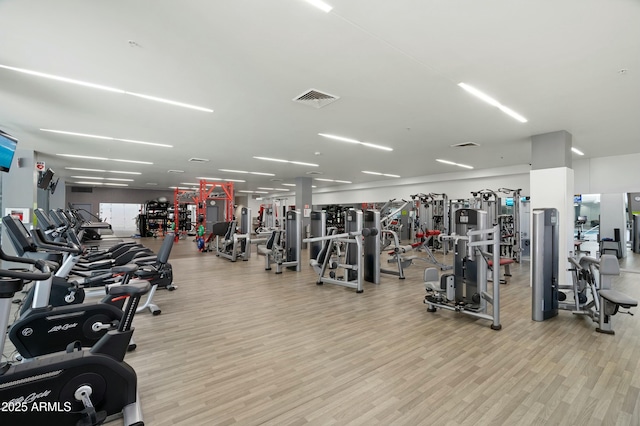 workout area featuring wood finished floors and visible vents