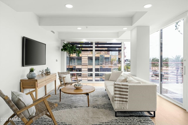 living area with light wood-style floors and recessed lighting