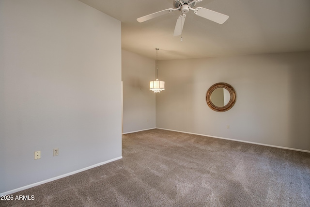 spare room featuring ceiling fan, vaulted ceiling, and carpet