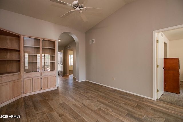 interior space with lofted ceiling, hardwood / wood-style floors, and ceiling fan