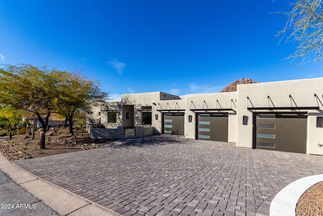 pueblo-style home with a garage