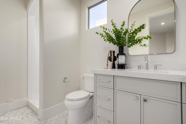 bathroom featuring tile patterned flooring, vanity, toilet, and walk in shower