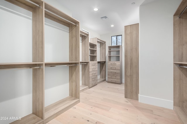 spacious closet featuring light hardwood / wood-style floors