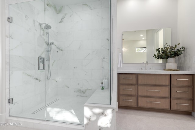 bathroom featuring tile patterned flooring, vanity, and a shower with door