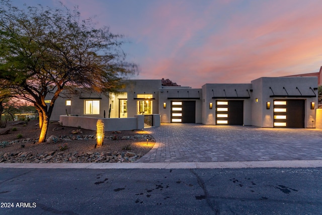 view of front of home with cooling unit and a garage