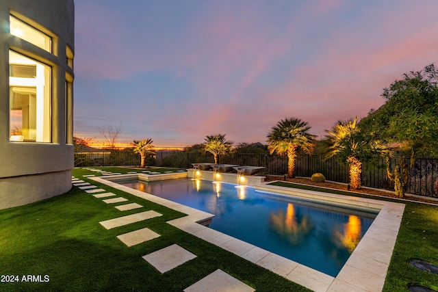 pool at dusk with a yard