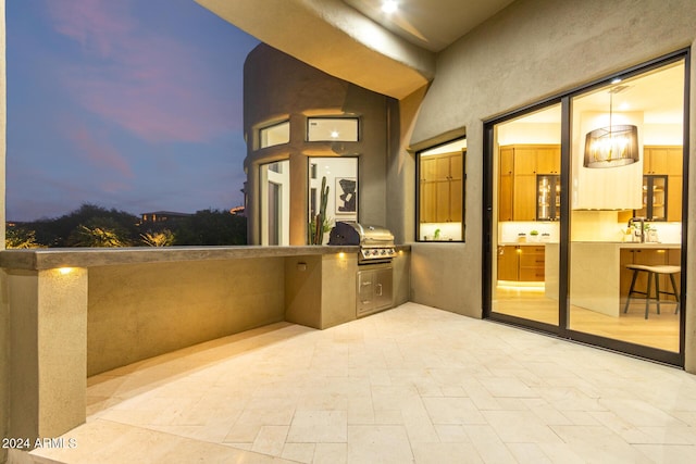 patio terrace at dusk with a grill