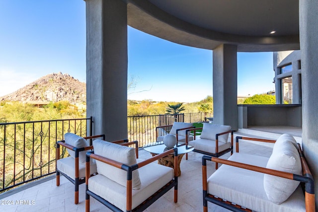 view of patio / terrace with a mountain view and a balcony