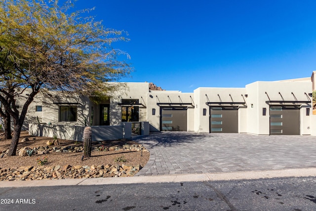 pueblo-style home with a garage