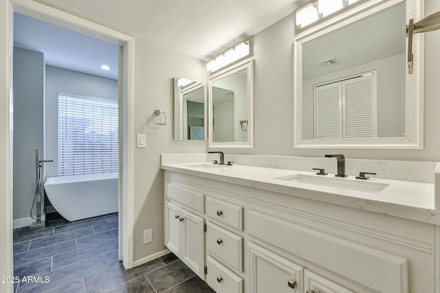 bathroom featuring vanity and a tub