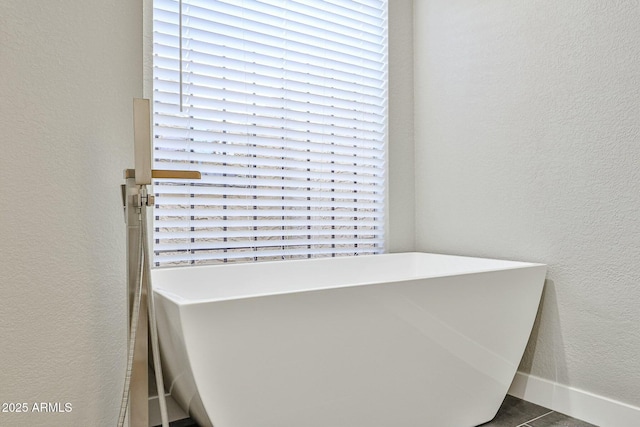 bathroom featuring a washtub