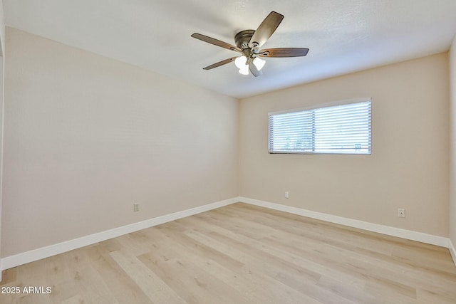 empty room featuring ceiling fan and light hardwood / wood-style flooring