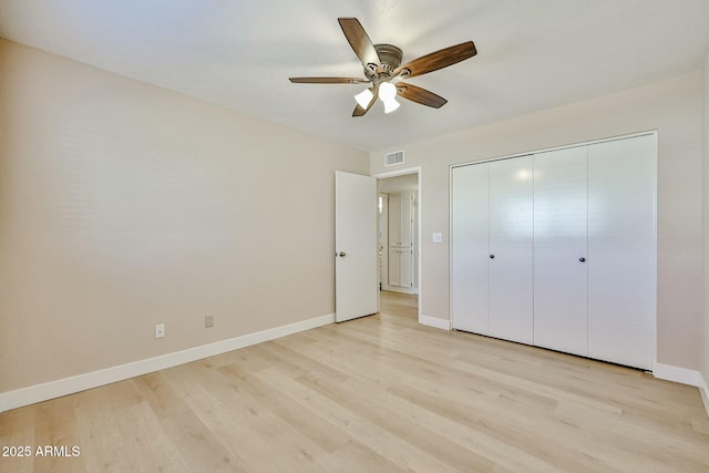 unfurnished bedroom featuring ceiling fan, light hardwood / wood-style flooring, and a closet