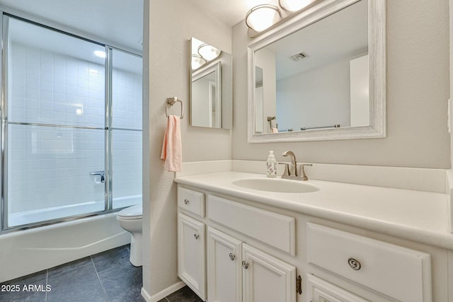 full bathroom with tile patterned floors, toilet, vanity, and combined bath / shower with glass door