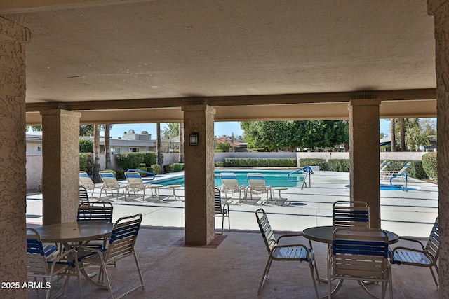 view of patio / terrace with a fenced in pool