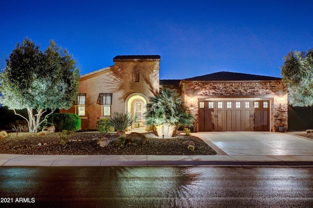 mediterranean / spanish house with driveway and a garage