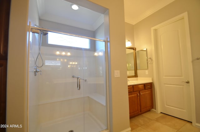 bathroom with crown molding, vanity, a shower stall, and tile patterned floors