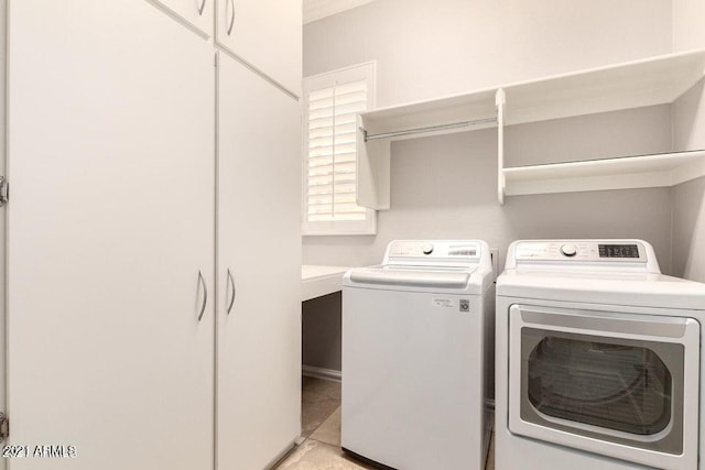 laundry area with washing machine and dryer and cabinet space