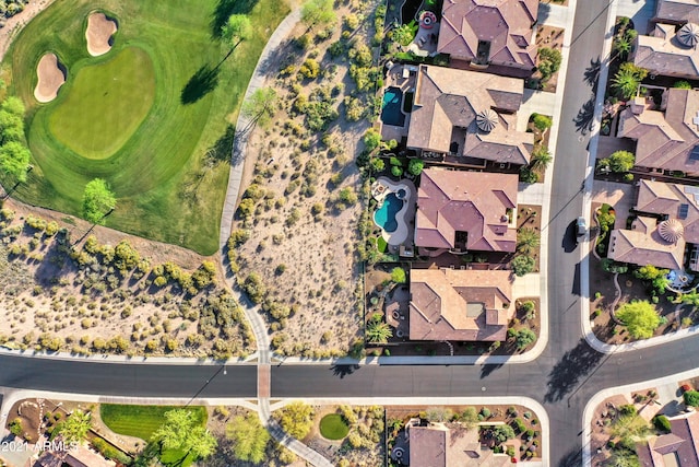 drone / aerial view with golf course view and a residential view