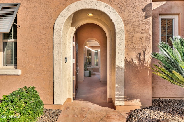 entrance to property featuring stucco siding