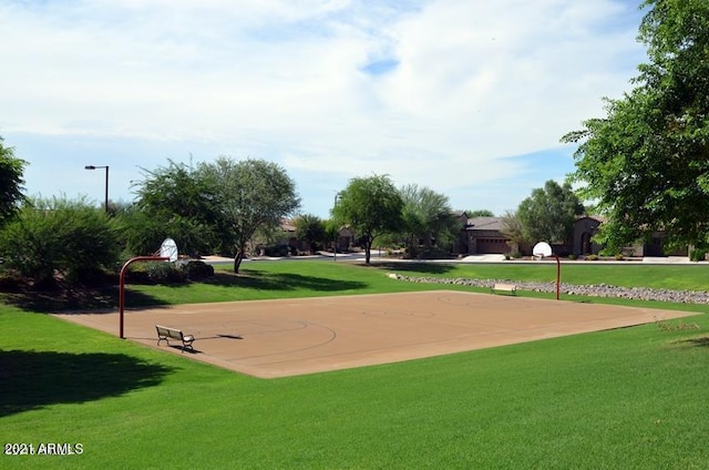 view of home's community featuring community basketball court and a lawn