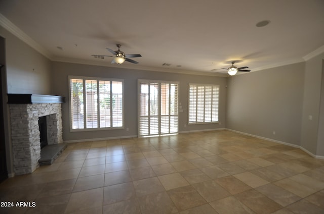 unfurnished living room featuring ornamental molding, plenty of natural light, and a stone fireplace