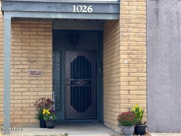 entrance to property with brick siding