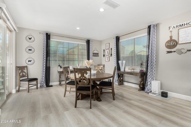 dining area featuring light hardwood / wood-style flooring and a healthy amount of sunlight