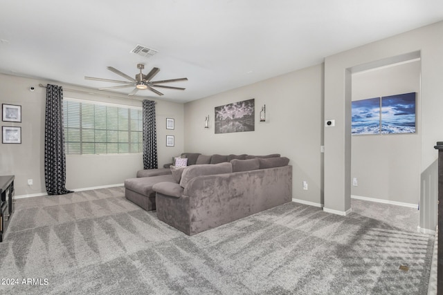 carpeted living room with ceiling fan