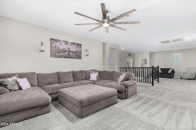 carpeted living room with ceiling fan